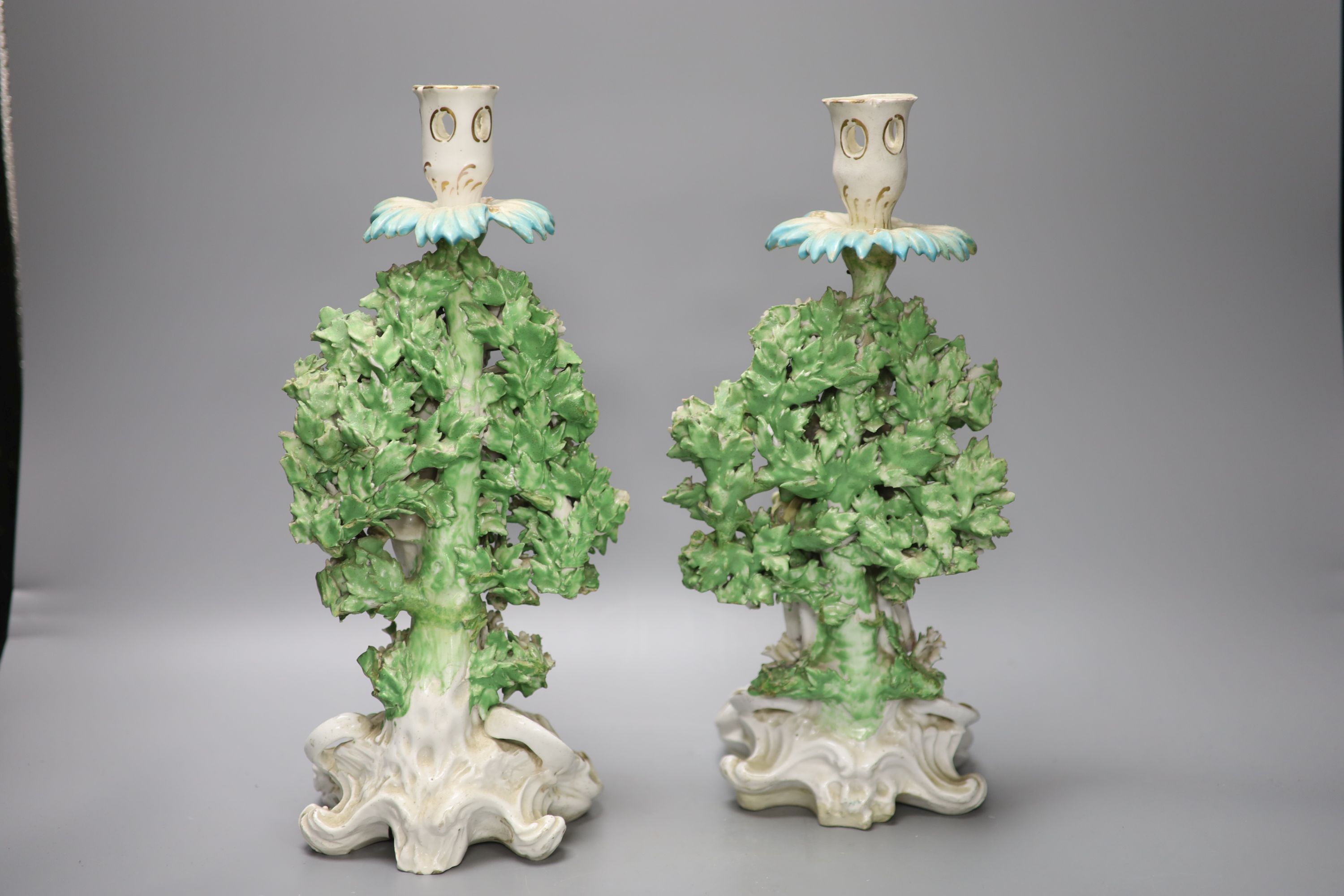 A pair of Derby bocage figural candlesticks, of the Italian farmer and his wife, c.1770, height 31.5cm